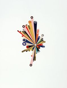 a clock made out of colored pencils on a white background