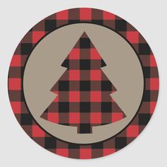 a red and black plaid christmas tree on a round sticker with an oval background