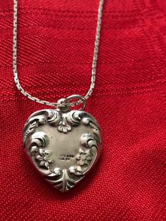 "Antique/Vintage Sterling Silver Heart Pendant with Chain Marked Holland 925 on the Heart and Sterling on the Chain. Signed 925 Sterling Silver Floral Heart Pendant. the beautiful flowered pendant measures 3/4\" wide x just over 3/4\" in length. The pendant is vintage/antique but the chain may be newer, marked STERLING on the clasp. The chain is a beautiful 24\" long with a wonderful link pattern. A very special necklace for a special person who appreciates vintage and antique silver. This was i Vintage Sterling Silver Necklace For Anniversary, Classic Heart Jewelry For Collectibles, Vintage Sterling Silver Locket Necklace, Heirloom Sterling Silver Necklace For Anniversary, Formal Engraved Heart Pendant Necklace, Vintage White Gold Sterling Silver Necklace, Formal Engraved Heart Cut Necklaces, Formal Engraved Heart Cut Necklace, Formal Vintage Necklace