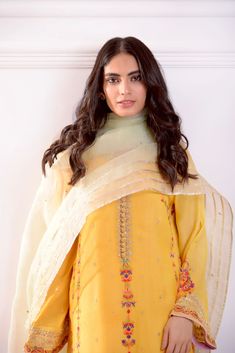 Rendered on pure mustard yellow cotton net with intricate multi hues embroidery in festive tones, the neckline is adorned with gold zardosi handwork craftsmanship, styled with a contrasting pure organza dupatta in mint green with signature Agha Noor gotah motifs and embellished flappers. Turn heads in this beautiful de Yellow Tissue Silk Kurta For Diwali, Pista Green Chanderi Kurta With Sheer Dupatta, Yellow Chikankari Embroidery Raw Silk Salwar Kameez, Gold Cotton Silk Kurta With Chikankari Embroidery, Gold Kurta With Chikankari Embroidery In Cotton Silk, Yellow Raw Silk Salwar Kameez With Chikankari Embroidery, Gold Cotton Silk Churidar With Straight Kurta, Gold Embroidered Cotton Silk Salwar Kameez, Gold Cotton Silk Kurta With Dupatta