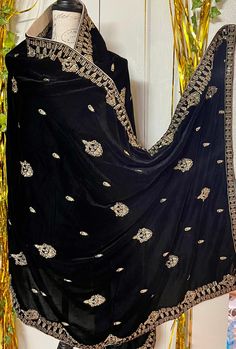 It is a beautiful shawl for women. It is a full big size shawl . It is embroided with zari thread,sequence work on it. It's length is 3 yards and width 1 yard. Very beautiful and soft velvet. Color black. No return or exchange please . New design. Elegant Scarf With Zari Work In Traditional Drape, Elegant Scarves With Zari Work In Traditional Drape, Elegant Scarves With Zari Work For Festive Season, Bollywood Style Embroidered Shawl For Celebrations, Elegant Traditional Wear With Shawl Dupatta, Elegant Traditional Wear With Dupatta Shawl, Elegant Festive Scarves With Zari Work, Party Velvet Saree With Resham Embroidery, Elegant Velvet Dupatta In Traditional Drape