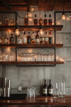 bottles and glasses are lined up on the shelves in a bar with lights behind them