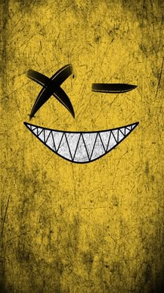 a smiley face drawn in black and yellow on a grungy background with scissors