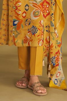 Dandelion yellow A-line kurta with ikat, floral print and gold embroidery in center panel. Paired with narrow pant and gota embroidered dupatta. - Aza Fashions Designer Yellow Kurta With Printed Motifs, Designer Wear Yellow Kurta With Printed Motifs, Designer Yellow Kurta For Spring, Yellow Silk Sets With Floral Print, Yellow Silk Floral Print Sets, Yellow Floral Print Silk Sets, Yellow Resham Embroidery Sets, Yellow Floral Print Kurta For Diwali, Designer Yellow Floral Print Dress