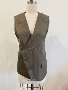 Semi-formal Sleeveless Blazer With Buttons, Fitted Sleeveless Vest With Hidden Button Closure, Elegant Fitted Vest With Asymmetrical Design, Elegant Fitted Asymmetrical Vest, Tailored Sleeveless Blazer With Buttons, Business Vest With Hidden Button Closure, Sleeveless Business Vest With Hidden Button Closure, Asymmetrical Fall Workwear Vest, Sleeveless Business Vest With Buttons