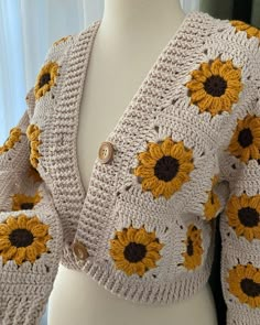 a crocheted sweater with sunflowers on the front and back, made to look like a cardigan