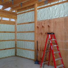 a ladder is standing in the middle of a room with insulation on the walls and ceiling