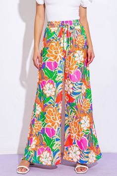 A printed woven pant featuring elasticized waist, front tie and wide leg. Matching top IT13075Details:Self : 100% PolyesterSize & Fit- Model is 5`8" And Wearing Size Small- Measurements Taken From Size Small- Approx. Length: 42" Summer Wide Leg Pants With Floral Print, Summer Wide Leg Floral Print Pants, Summer Floral Print Wide Leg Pants, Summer Floral Print Wide-leg Pants, Spring Day Out Printed Wide Leg Pants, Printed Wide Leg Pants For Spring Day Out, Vacation Patterned Pants With Elastic Waistband, Patterned Pants With Elastic Waistband For Vacation, Summer Wide Leg Bottoms With Bold Print