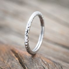 Product Details Ring Style: A dainty-style women's stacking band shown in 14k white gold and has a hammered finish, with delicate and ornate details and is available with many center stone options Width: The width of the ring pictured is approximately 1-2mm wide Materials: solid metal 14K white gold stacking band Customizable: Because each ring is handcrafted to order, we can customize yours using unique materials, gemstones, or design features, often without any added cost! We can even use personal materials that you send! Basic customizations, such as material swaps, can be accommodated by simply adding a request in the “Custom Requests” section during checkout. For more extensive customizations, please feel free to contact us! We would be honored to make your ring even more meaningful! Heirloom Style White Gold Stackable Rings, Elegant Hammered Sterling Silver Stackable Rings, White Gold Heirloom Stackable Rings, Dainty Stackable Rings With Polished Finish, Dainty Adjustable Stackable Rings With Polished Finish, Adjustable Dainty Stackable Rings With Polished Finish, Hammered Stackable Rings For Wedding, Sterling Silver Stackable Fine Jewelry Bands, Timeless Stackable 14k White Gold Jewelry