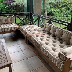 two couches sitting on top of a tiled floor