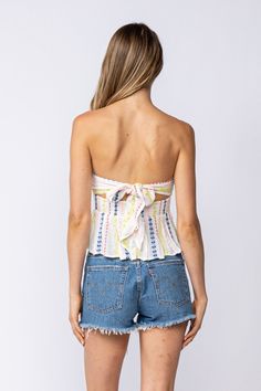 Nothing is as perfect as a sunshine-filled day and the Amelia White Embroidered Strapless Top! Lightweight, woven fabric shapes this ideal summer top that features a white embroidered print throughout as it shapes a strapless bodice that wraps around and ties in the back, a smocked waist, and flouncy, slightly cropped peplum hem. DETAILS & CARE Rayon/LINING: Polyester. Hand Wash Cold. Imported. ORDERS, SHIPPING & RETURNS Orders, Shipping, & Returns Bohemian Tube Top For Spring Vacation, Off-shoulder Tops For Beach Season, Sleeveless Beachwear Tops For Spring, Summer Crop Top With Smocked Bodice, Summer Crop Top With Smocked Bodice For Day Out, Summer Vacation Crop Top With Smocked Bodice, Spring Beach Top With Smocked Bodice, Spring Beach Tube Top With Smocked Bodice, Spring Vacation Smocked Bodice Crop Top