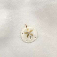 Legend has it that finding a sand dollar during a beach stroll is considered a lucky omen. So take a little bit of the beach and good luck with you wherever you go with our gorgeous Sand Dollar Charm. Real sand dollars are preserved and painted by hand in our MA studio sand dollars measure approximately 3/4 in to 1 inch. sterling silver or 14kt gold fill jump ring Preppy Jewelry, Sand Dollars, Sand Dollar, 14kt Gold, Jump Rings, Good Luck, 1 Inch, The Beach, Charms