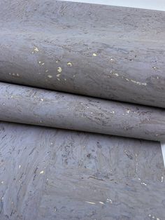 three rolls of gray marble sitting next to each other