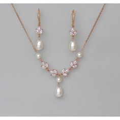 a necklace and earring set with pearls, crystals and diamonds on a white background