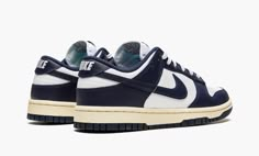 The Nike Dunk Low “Vintage Navy” is a classic two-tone, white-and-navy colorway for the retro basketball shoe with a decidedly throwback vibe.  The “Vintage Navy” edition of the Dunk Low calls back to original styles found in the “Be True to Your School” pack of college basketball-inspired colorways from 1985.  The shoe’s upper features a white leather base with contrasting Vintage Navy-colored leather overlays and Swoosh branding.  White “Nike” branding is embroidered on the heel, and navy “Nik Nike Dunk Low Vintage Navy, Nike Heels, Sneakers Box, Kobe Shoes, Navy Blue Shoes, Shoe Wishlist, Basic Hoodie, Sneaker Release, Nike Vintage