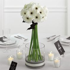 a vase filled with white flowers on top of a table