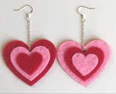 two heart shaped felt earrings hanging from chains