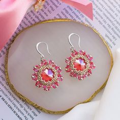 These pink earrings are made of high quality Japanese seed beads and has silver plated fittings. It will not tarnish or cause allergies. They are suitable for both casual and evening looks. The earrings are made in soft pink color, in the shape of a flower. The center is a Swarovski crystal, it shimmers and plays beautifully with its facets in the light. Buy these handmade earrings as a gift for your mom, daughter, sister or friend. The earrings are packaged in a beautiful gift box. You won't ha Pink Beaded Crystal Drop Earrings, Pink Beaded Drop Crystal Earrings, Pink Beaded Crystal Earrings For Party, Elegant Pink Earrings With Faceted Beads, Crystal Beaded Earrings As Gift, Crystal Beaded Earrings With Round Beads As Gift, Elegant Pink Beaded Earrings With Faceted Beads, Pink Beaded Dangle Earrings With Bead Caps, Pink Dangle Beaded Earrings With Bead Caps