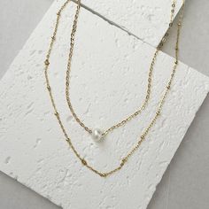 Gold Layered Necklaces, set of 2 necklaces - Goldfilled necklace with one natural pearl and a gold-filled chain necklace.2 separate necklaces so you can wear each necklace separately or together as a layered.Adjustable necklaces - each necklace comes with a 2" extension chain.♥ Necklaces length are 15 inches + 2" extension chain.If you wish for a different size contact us.♥ This necklace set is our recommendation for a Bridesmaid Gift.♥ Comes in a beautiful package ready for gifting. Gold Delicate Chain Pearl Choker, Gold Pearl Choker With Delicate Chain, Gold Pearl Choker Necklace With Delicate Chain, Layering Pearl Jewelry With Double Chain, Pearl Double Chain Jewelry For Layering, Pearl Double Chain Necklace For Layering, Minimalist White Double Chain Necklace, Double Strand Layered Necklace With Pearl Charm, Gold Double Strand Pearl Necklace With Adjustable Chain