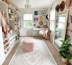 a bedroom with a pink ottoman and white shelves filled with hats, shoes and other items