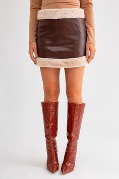 The Take Me To The Alps Vegan Fur Lined Leather Mini Skirt is crafted from brown vegan faux leather and lined with vegan fur along both edges for a luxurious finish. Best Seller Faux Fur: 100% Polyester Faux Leather: 100% Polyurethane Mini Skirt Premium Quality Model is 5'8 and wearing a size Small Styled with: Take Me To The Alps Vegan Fur Half Zip Up Jacket Winter Brown Lined Mini Skirt, Brown Faux Leather Mini Skirt For Party, Trendy Brown Faux Leather Mini Skirt, Tan Leather Mini Skirt, Brown Faux Leather Mini Skirt, Faux Leather Outfits, Denim Skirt Fashion, Faux Leather Mini Skirt, Chic Fall Outfits