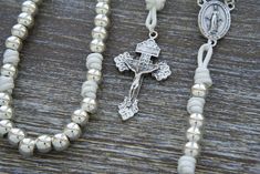 Elevate your spiritual connection with the "Divine Elegance" Paracord Rosary, a perfect blend of strength and grace. This exquisite rosary is a testament to the enduring faith within you, meticulously handcrafted with 10mm alloy metal beads that radiate elegance and durability. As each bead shines brilliantly in the light, "Divine Elegance" exudes a timeless charm that's reminiscent of a heavenly gift. Drenched in purity and symbolism, this rosary boasts all-silver colored beads, elegantly paire Enduring Faith, Paracord Rosary, Gift From Heaven, Miraculous Medal, Spiritual Connection, Spiritual Journey, Metal Beads, Paracord, Rosary