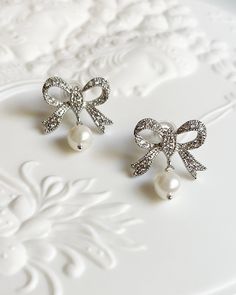 Silver Plated Brass Rhinestone Bow Earrings. Cubic zirconia and pearl shell pearls. Perfect French Style Summer earrings. All items come in a gift box ready to gift. To see more please visit  https://www.etsy.com/shop/BijouLimon Bijou Limon jewelry collections present a romantic French spin on the latest jewelry trends. Based on the US West Coast but French at heart, Bijou Limon interprets the current jewelry trends and delivers timeless pieces that make you swoon. From Necklaces, Earrings, Brac Romantic Style Personality, Pearl Earrings Diamond, Pearl Core, Romantic Eclectic, Themed Tea Party, Stained Glass Earrings, Tea Party Tea, Eclectic Jewelry, Pearl Birthstone