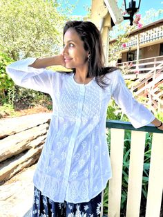 Theigh length tunic /Kurta with full front button opening is one of the gorgeous attire for warm weather. Airy and lightweight companion for a hot summer day. This beautiful Hand embroidered tunic/top is ideal for any functions/parties. If you want a classic look then pair it with leggings, skinny jeans, capri. This is a contemporary reflection of traditional Indian Chikan embroidered ethics which had originated centuries ago in Lucknow. Chikansazi being the exquisite needlework of fine and deli Hand Embroidered Tunics, Embroidered Tunic Top, White Tunic, Embroidered Tunic, Traditional Indian, Summer Day, Sewing Tips, Beautiful Hand, Tunic Top