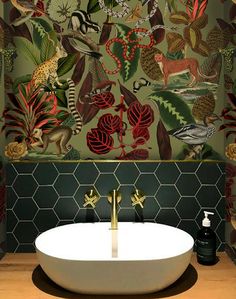 a bath room with a sink and a wallpapered pattern on the wall behind it