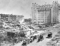 an old black and white photo of construction in front of a large building that is being demolished