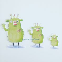 three green monsters with crowns on their heads are standing next to each other in front of a white background