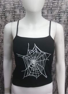 This is a black sleeveless Spiderwebs cropped tank top. This has a Spiderweb image screen printed on the front. 57% cotton/ 38% polyester/ 5% Spandex These are handmade screenprinted and slightly vary from the photo. Please feel free to email me any questions. Thanks for looking. Due to an influx of incorrect addresses if a package is returned, you must pay the shipping cost to resend the item to you. I do not do exchanges and I do not take returns unless the item is damaged. I thoroughly check Emo Black Top For Festival, Y2k Black Crop Top For Alternative Fashion, Fitted Sleeveless Crop Top For Halloween, Black Cotton Grunge Tank Top, Y2k Fitted Crop Top For Halloween, Fitted Gothic Tank Top For Streetwear, Sleeveless Stretch Punk Crop Top, Emo Style Sleeveless Cotton Top, Gothic Crop Top For Halloween Festival