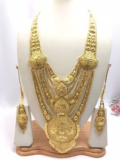 Handmade Indian Jewelry Asian Wedding Bridal Jewellery Party Ethnic Wear 22ct Gold Plated Bridal Necklace Set Rani Haar Bridal Jewellery Set  PLEASE NOTE, This Item Is Not Real Gold .Only Good Quality Gold Plated Jewellery .it is Artificial Jewellery.  It is a perfect match with formal attire on special occasions or with casual wearing.  Slight Colour variations possible due to difference in screen and photograph Care instructions Keep Jewellery away from direct heat, water, perfumes, deodorants Festive Gold Cutdana Tikka, Chandbali-shaped Yellow Gold Bridal Necklace For Puja, Yellow Gold Chandbali Bridal Necklace For Puja, Gold Heavy Bridal Necklace For Wedding, Gold Meenakari Tikka For Ceremonial Occasions, Gold Meenakari Tikka For Ceremonial Use, 22k Gold Jewelry With Zari Work, Ceremonial Gold Meenakari Tikka, Festive Gold-plated Tikka