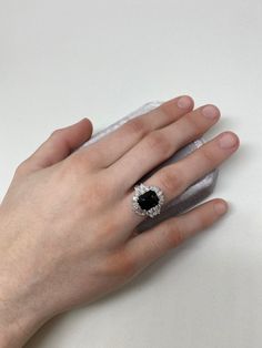 Start a conversation with this show stopping Art Deco inspired ring. A show stopping 4.22 ct black Spinel is the centerpiece of this creation, surrounded by a combination of 1.6 ct VS quality round, pear, and tapered baguette shaped diamonds. Inspired by the Art Deco period, we have created both contrast and symmetry with the depth of black hue from the Spinel and the contrast of the scintillating symmetrical diamonds that surround it. A collector piece sure to be an heirloom for many generation Luxury Cluster Ring With Round Cut Gemstone, Classic Black Baguette Cut Rings, Elegant Evening Rings With Center Stone, Timeless Black Jewelry With Center Stone, Exquisite Evening Gemstone Rings, Black Baguette Cut Ring For Formal Occasions, Formal Black Round Cut Rings, Formal Black Baguette Cut Rings, Luxury Halo Ring With Gemstone For Gift