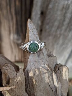 Green Matrix Jasper ring, wire wrapped in recycled sterling silver wire. Turquoise jasper stone is 8mm. Rings are made to order in your size. Ring appears larger in photos to show detail. Since each ring is handmade and gemstones vary in color tone and pattern, there may be slight differences in each ring. Every order comes in a small gift box. Your order will be made and shipped within 1-7 business days of received payment. Returns and exchanges are accepted within a reasonable time frame. Alwa Adjustable Silver Turquoise Ring For Healing, Artisan Wire Wrapped Round Rings, Chrysocolla Ring Jewelry Gift, Artisan Wire Wrapped Rings, Hand Wrapped Green Ring For Gift, Green Wire Wrapped Rings, Adjustable Green Wire Wrapped Rings, Silver Chrysocolla Rings For Gift, Green Wire Wrapped Promise Ring