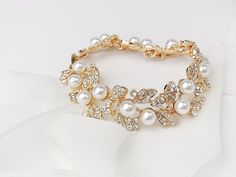 This is a favorite among our brides looking for a classic bracelet to finish their wedding day accessories. Each piece is handmade in the USA. DETAILS *As shown, the bracelet soft off white pearls and clear crystals throughout *Adjustable sizing *Finish is available in Gold or Silver, choose at checkout The goal of your wedding accessories is to compliment your dress and your overall wedding day look, not overpower it. We want our products to make you feel beautiful and special on your wedding d Formal Gold Pearl Bridal Accessories, Gold Pearl Bridal Accessories For Wedding, Wedding Pearl Bracelet With Pearl Drop, Delicate White Bracelet For Wedding, Formal White Pearl Bracelets, Formal White Pearl Embellished Bracelets, Wedding Beaded Bangle Pearl Bracelet, Classic Pearl Drop Bracelet For Wedding, Pearl Beaded Bangle Bracelets For Wedding