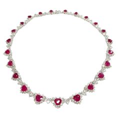 Prepare to make a statement with this breathtaking IGI certified 26.58ct Ruby & 17.85ct Natural Diamonds Necklace in 18K White Gold. Crafted with exquisite artistry and attention to detail, this extraordinary piece is a true masterpiece that showcases the mesmerizing beauty of rubies and diamonds. The focal point of this necklace is the 23 heart-shaped natural rubies, totaling 26.58 carats, each exuding a deep red hue that is synonymous with the finest Burmese rubies. Certified by IGI to ensure their origin from Burma, these rubies are renowned for their exceptional quality and lustrous color, making them a rare and coveted gemstone in the world of jewelry. Complementing the rubies are a total of 414 round brilliant diamonds, weighing 17.85 carats, meticulously set in heart-shaped patterns Luxury Bollywood Ruby Necklaces, Rubies And Diamonds, Ruby And Diamond Necklace, Diamonds Necklace, Mesmerizing Beauty, Ruby Necklace, Ruby Jewelry, Ruby Diamond, Natural Ruby