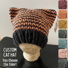 a knitted cat hat sitting on top of a mannequin head