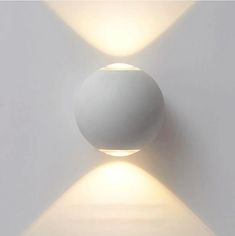 a white wall mounted light with two lights on it's sides and one is turned off