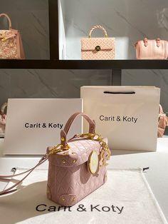 two pink purses sitting next to each other on display