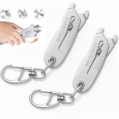 two metal scissors with handles and hooks attached to each other