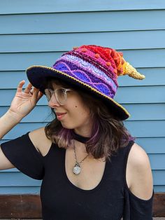 a woman wearing a colorful hat and glasses