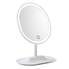 a round mirror sitting on top of a white table