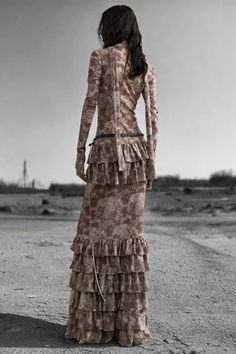 The Nomad Dune Layered Maxi Dress combines an earthy, distressed look with luxurious ruffled layers. Its floor-length silhouette, loose fit, and lace-up front detail evoke a rugged, post-apocalyptic vibe. This dress makes a bold, rebellious statement perfect for daring, avant-garde fashionistas. Features: Material: Cotton, Polyester blend Fit: Slim, flowy silhouette Style: Distressed, Layered, Floor-length Decoration: Ruffled tiers Occasion: Glamorous/Posh, Statement piece Season: Summer/Autumn Layered Maxi Dress, Dress Pant, Post Apocalyptic, New Instagram, Season Summer, Dress Making, All Seasons, Floor Length, Ruffles