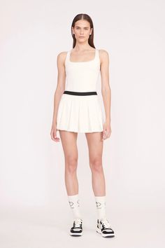 A pleated activewear mini skirt with elastic waistband and built-in shorts. The Double Skirt features moisture-wicking fabric technology to help you stay dry and comfortable on and off the court. Sporty Summer Tennis Skirt With Built-in Shorts, Sports Mini Tennis Skirt With Built-in Shorts, White Tennis Skirt With Elastic Waistband, White Short Tennis Skirt With Elastic Waistband, Athleisure Nylon Tennis Skirt For Workout, Sporty Pleated Mini Length Bottoms, Sporty Pleated Mini Skirt For Spring, Sporty Pleated Mini Bottoms, Summer Mini Pleated Skirt With Built-in Shorts