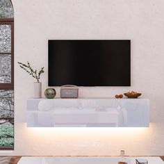 a large flat screen tv mounted to the side of a wall in a living room