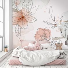 a bedroom with pink flowers on the wall and white bedding in front of it