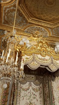 an elaborately decorated room with chandeliers and wallpapered walls in the background