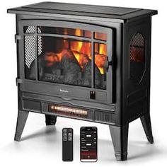 an electric stove with remote controls on the side and fire in the fireplace behind it