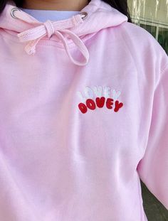 An embroidered 'Lovey dovey' hoodie! A super cute and multi-colour design that stands out on the front of the hoodie For the perfect oversized look, I would recommend sizing up one size than your regular as the hoodies run on the smaller side. The hoodies are 50/50 cotton and polyester. They're the perfect mid-weight for a soft and comfy, all-year round hoodie. Made by a 19-year-old entrepreneur! All packaging is eco-friendly and 100% recycled. Pink Hoodie With Embroidered Logo For Spring, Cute Hoodie With Embroidered Graphics For Streetwear, Cute Hooded Sweatshirt With Embroidered Graphics, Cute Embroidered Hoodie For Streetwear, Pink Hooded Sweatshirt With Embroidered Logo, Casual Pink Hoodie With Embroidered Logo, Pink Long Sleeve Hoodie With Embroidered Text, Cute Hooded Top With Embroidered Logo, Cute Hooded Tops With Embroidered Logo